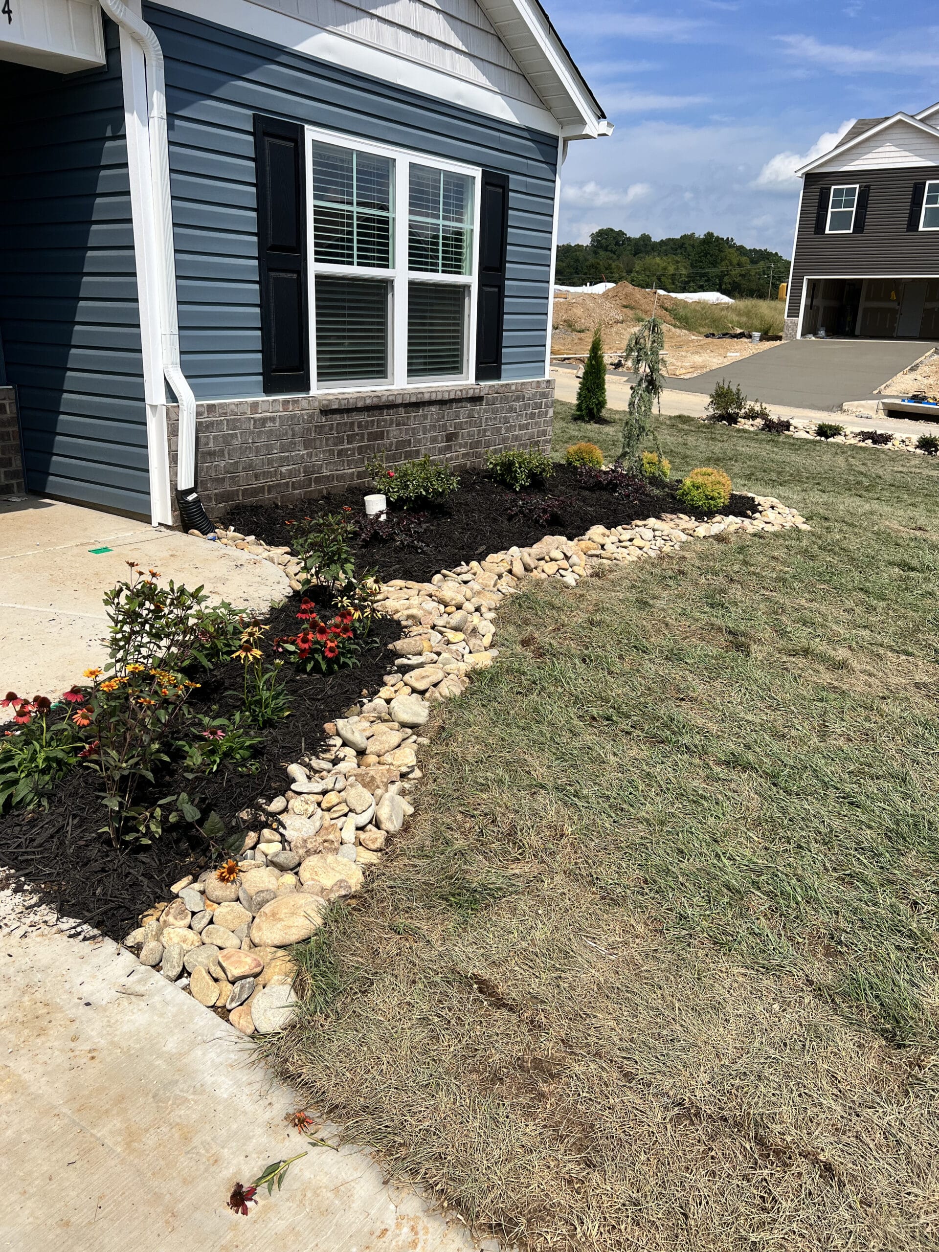 Flower bed with pavers around home Flower bed with rocks around home Appalachian Landscaping