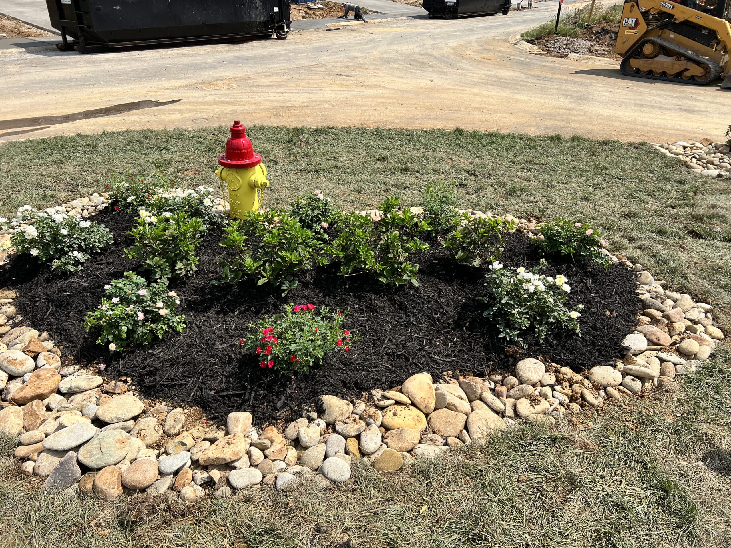 curb appeal around fire hydrant Flower bed with rocks around home Appalachian Landscaping