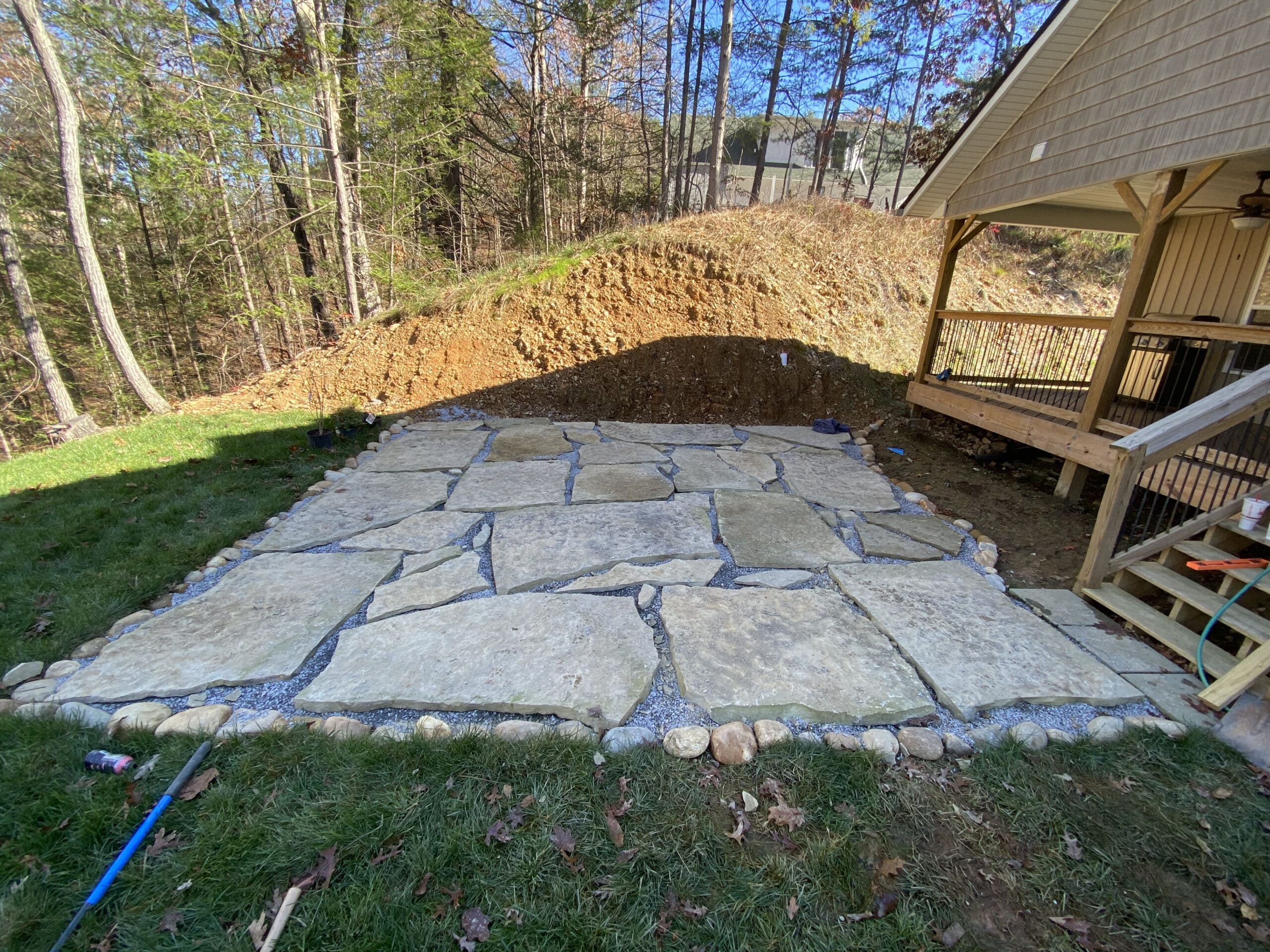 ground level rock patio Flower bed with rocks around home Appalachian Landscaping