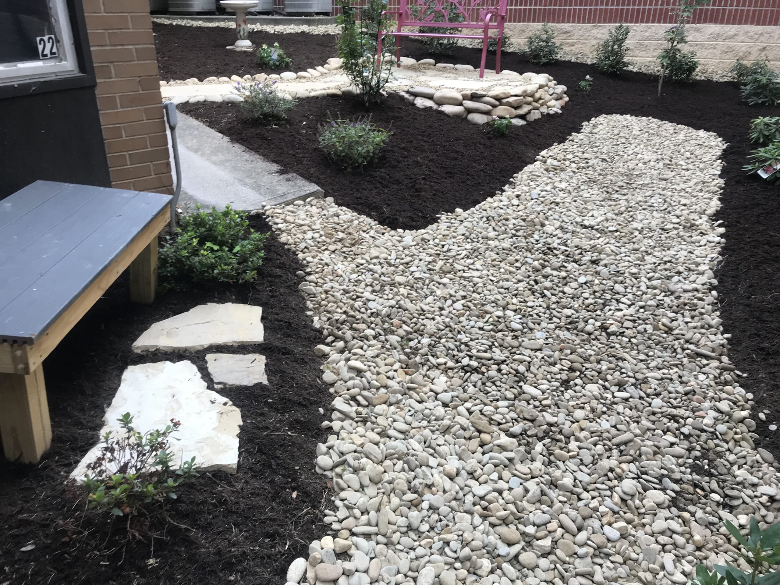 public seating area with rocks by Appalachian Landscaping
